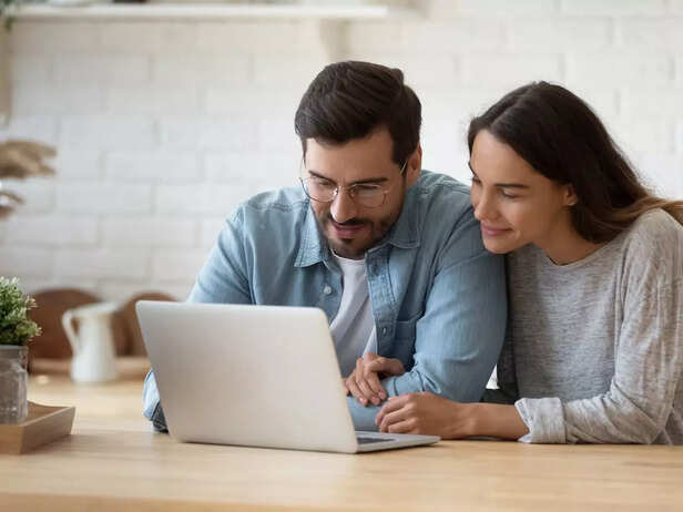 couple checking laptop