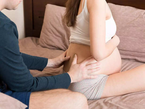 husband massaging pregnant woman massaging