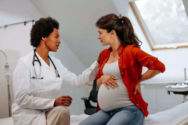 pregnant woman talking to doctor