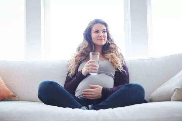 pregnant woman drinking water