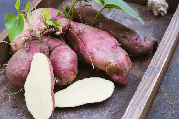 Sweet potato and carrots in a wooden box.
