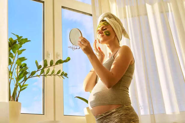 pregnant woman putting on a kiwi mask